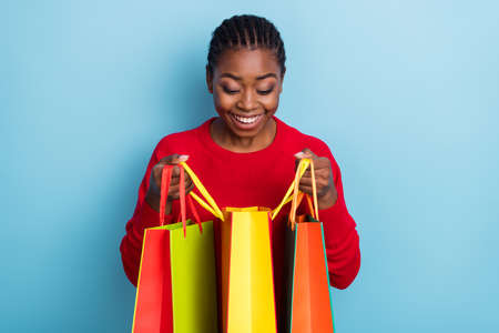 Photo of hooray millennial brunette lady look bag wear red pullover isolated on blue color backgroundの写真素材