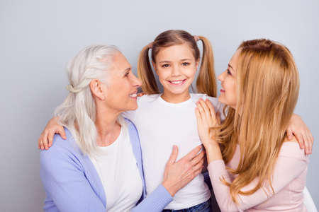 Portrait of positive peaceful people cuddle have good mood beaming smile isolated on grey color backgroundの写真素材