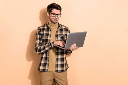 Photo of expert it specialist guy typing email netbook communicate partners isolated pastel color backgroundの写真素材