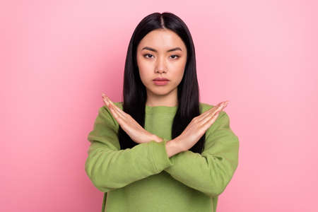 Photo of unhappy millennial lady show no wear green sweatshirt isolated on pink color background