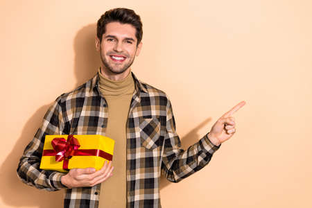 Photo of guy promoter demonstrate special offer package point empty space discounts isolated pastel color backgroundの写真素材