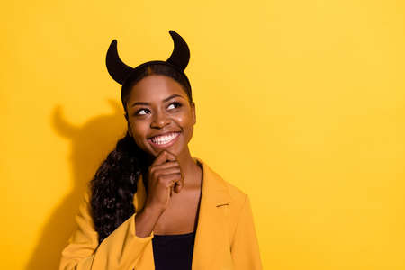 Portrait of attractive cheerful minded wavy-haired girl wearing horns deciding copy space isolated...