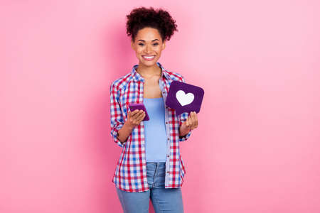 Photo of young pretty volume hairdo lady hold telephone like wear plaid shirt isolated on pink color backgroundの写真素材