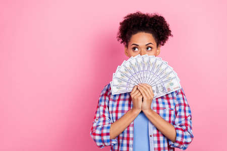 Photo of nice brunette lady hold money look ad wear plaid shirt isolated on pink color background