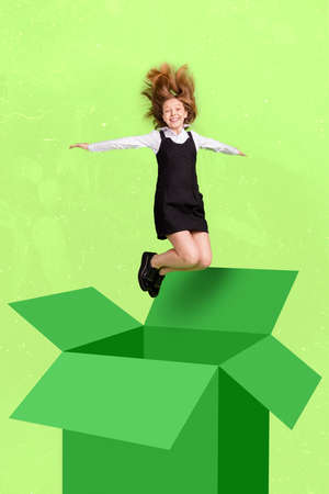 Full size vertical composite picture of delighted school girl jump out box fly isolated on drawing green backgroundの写真素材