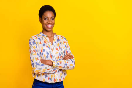 Portrait of successful person crossed arms empty space blank isolated on yellow color background
