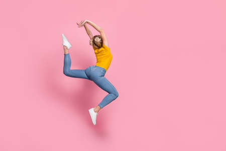 Full size rear spine photo of adorable carefree cute lady jumping fooling around isolated on pink...