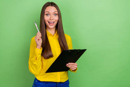 Portrait of attractive cheerful amazed girl employee writing plan solution copy space isolated over...