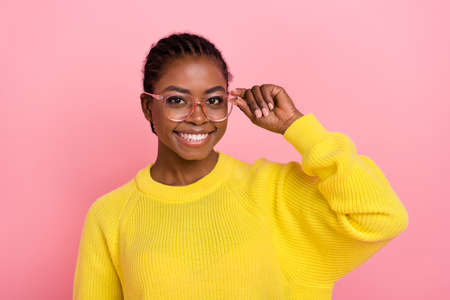 Photo of satisfied adorable lady hand touch eyewear toothy smile look camera isolated on pink color...