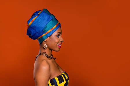 Photo of pretty adorable woman wear ethnic turban smiling looking empty space isolated brown color backgroundの写真素材