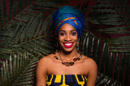 Portrait of gorgeous lady tradition accessories smile lipstick stand tropical forest behind isolated...
