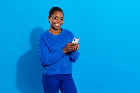 Portrait of attractive cheerful girl using gadget device blogging app chatting texting isolated over...