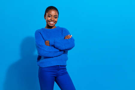 Portrait of attractive cheerful brunette girl folded arms copy space isolated over bright blue color...