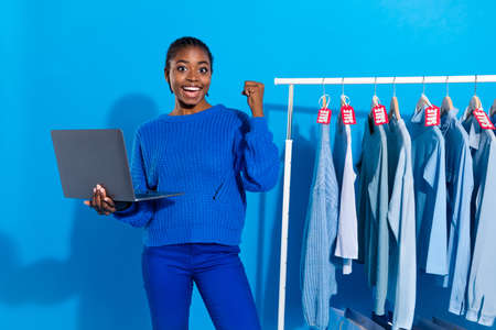 Portrait of attractive trendy cheerful lucky girl using laptop buying things Friday isolated over...