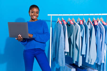 Portrait of attractive cheery girl using laptop buying new things wear look outfit isolated over...