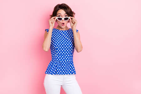 Photo of impressed millennial brunette lady open mouth wear glasses blouse jeans isolated on pink...