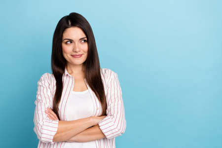 Portrait of attractive cheery minded long-haired girl thinking copy blank space folded arms isolated...