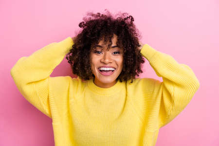 Photo of sweet charming woman dressed kitted pullover arms hairdo smiling isolated pink color backgroundの写真素材