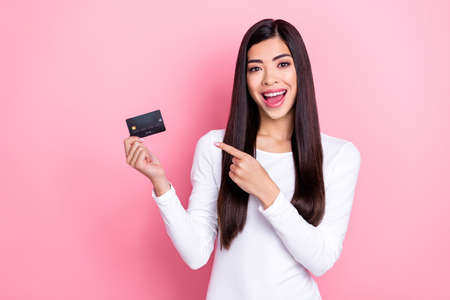 Photo of impressed millennial brunette lady index card wear white shirt isolated on pink color...