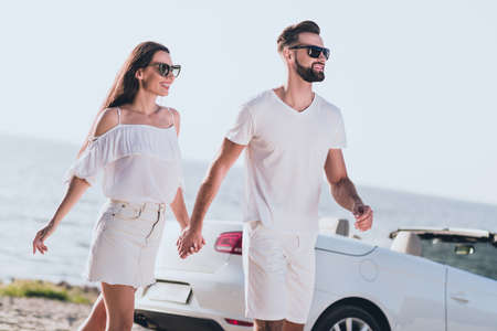 Photo of funky charming boyfriend girlfriend dressed casual outfit holding arms driving cabriolet...