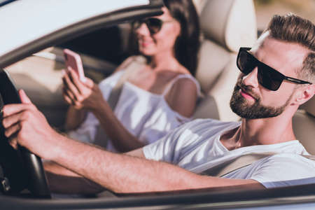 Photo of sweet funny husband wear casual clothes riding cabriolet looking road modern device outside countrysideの写真素材