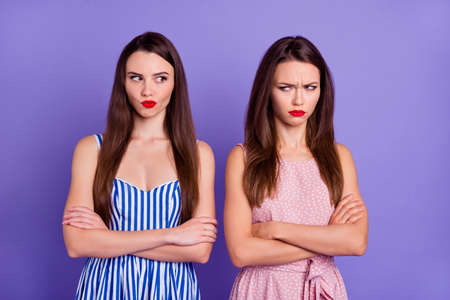Photo of unhappy sad two best friends dressed summer clothes arms folded having problems isolated purple color backgroundの写真素材