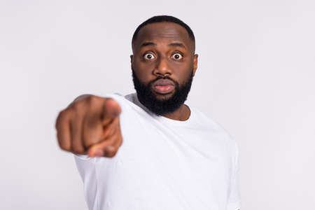Photo of scared shocked guy dressed casual t-shirt pointing finger you isolated white color backgroundの写真素材