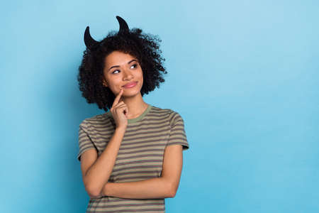 Photo of thoughtful lady creepy mystical creature decide empty space who scary next isolated on blue color backgroundの写真素材