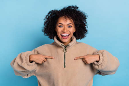 Photo of amazed excited lady point finger her weather outfit fiber textile isolated on blue color...