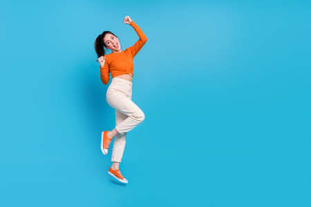 Full length photo of overjoyed ecstatic female raise fists in victory win money prize isolated on...