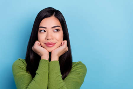 Portrait of attractive bewildered long-haired girl looking aside copy space deciding isolated over...