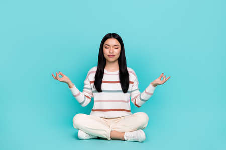 Photo of adorable calm peaceful young woman practice mindfulness open her chakras isolated on...