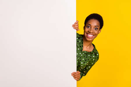 Photo of impressed funny androgynous person dressed smart casual standing white placard empty space...