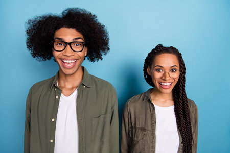Photo of two amazed guy lady excited specs discounts wear stylish trendy shirt isolated blue color...