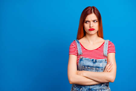 Photo of confident upset young lady dressed denim clothes arms folded looking empty space isolated...