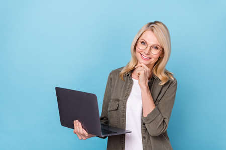 Photo of middle aged lady ceo use netbook decide partners start up report isolated blue pastel color...