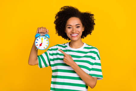 Photo of sweet young lady index clock wear green t-shirt isolated on yellow color background