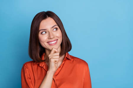 Portrait of attractive cheerful girl overthinking copy blank space solution isolated over bright blue color backgroundの写真素材