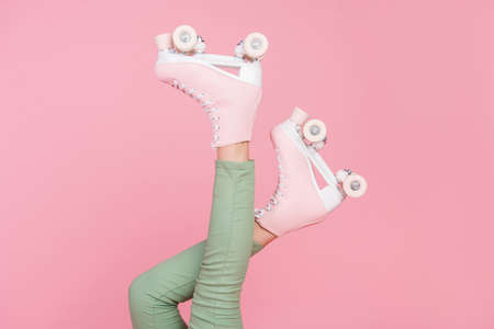 Cropped photo of slim legs wear pants roller skates sport hobby isolated over pastel color...