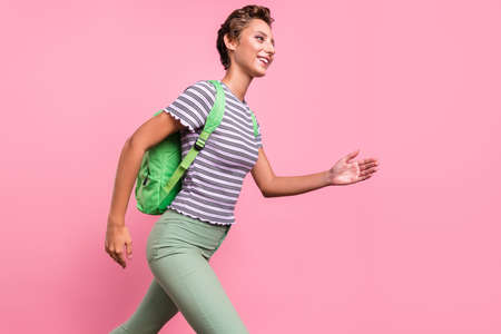 Profile photo of funky young student lady run wear bag white t-shirt jeans isolated on pink color...
