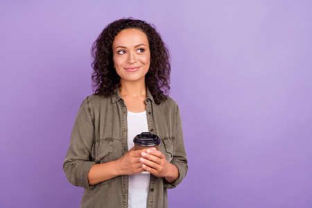 Photo of dreamy young happy afro american woman hold takeaway coffee look empty space isolated on...