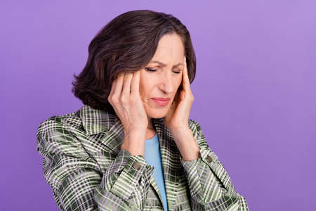 Photo old unhappy sad upset woman hold hands head bad mood ache suffer isolated on purple color...