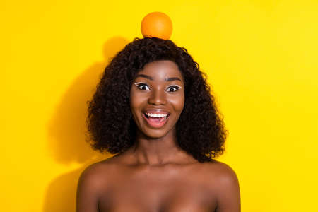 Photo of crazy foolish childish woman excited face orange head look camera isolated yellow color backgroundの写真素材