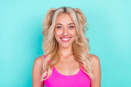 Photo of young attractive girl happy positive toothy smile glad isolated over turquoise color backgroundの写真素材