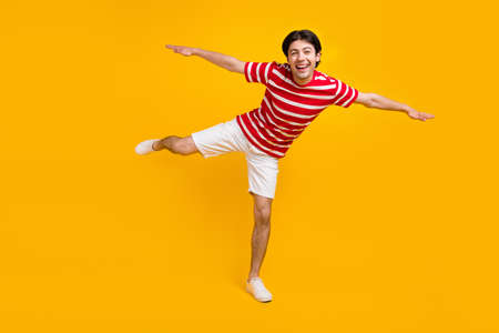 Full body photo of excited happy positive young man hands plane wings travel summer isolated on...