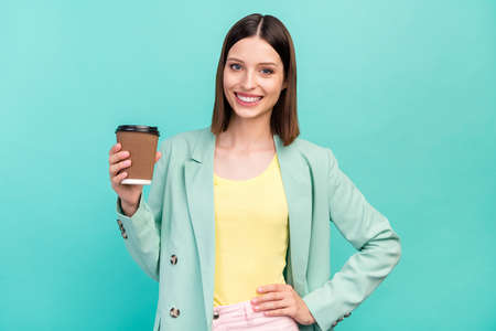Photo of sweet young brunette lady hold coffee wear jacket isolated on cyan color background