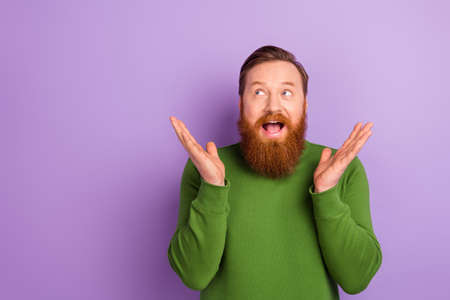 Photo of good mood overjoyed impressed guy see shopping sale promotion advert isolated on violet color backgroundの写真素材