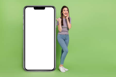 Full length body size view of beautiful cheerful amazed girl presenting copy space offer news...