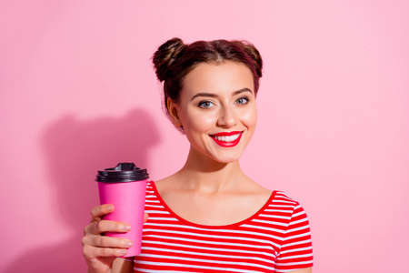 Photo of young good looking lady enjoy summer weather go on walk buy yummy herb tea isolated on pink color backgroundの写真素材