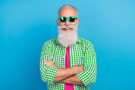 Photo of cheerful satisfied granddad crossed arms beaming smile isolated on blue color background